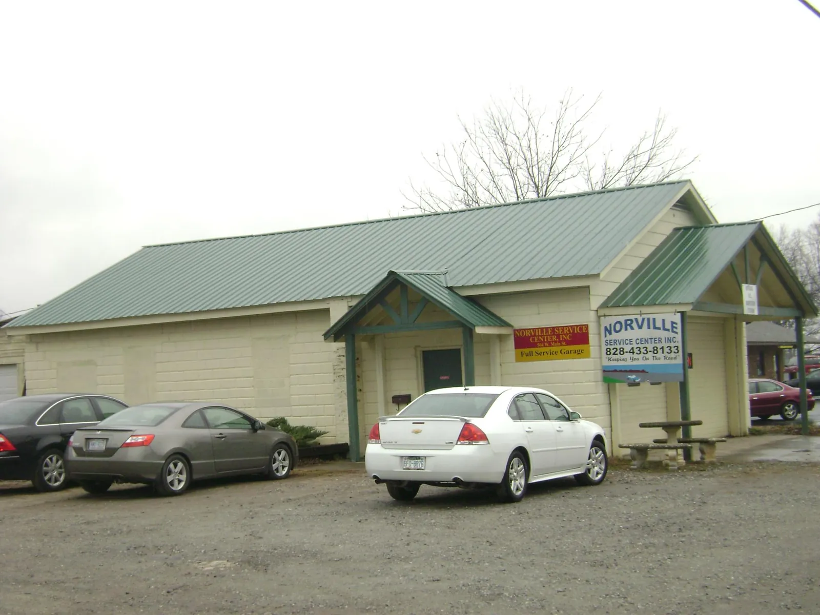 Green metal roof on a service garage with a covered entry in Millersburg